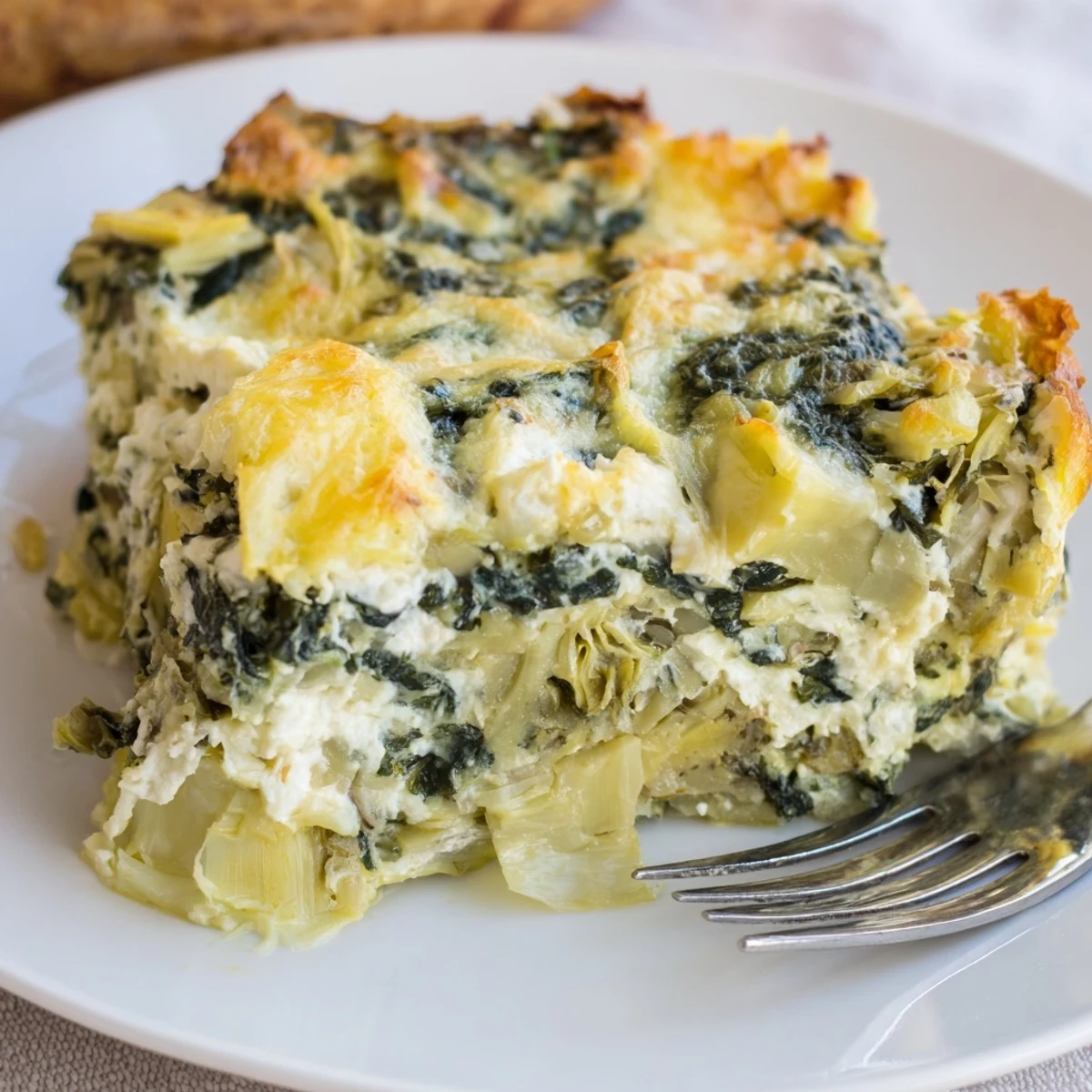 Delicious Cheesy Spinach and Artichoke Bake served warm, perfect for gatherings.