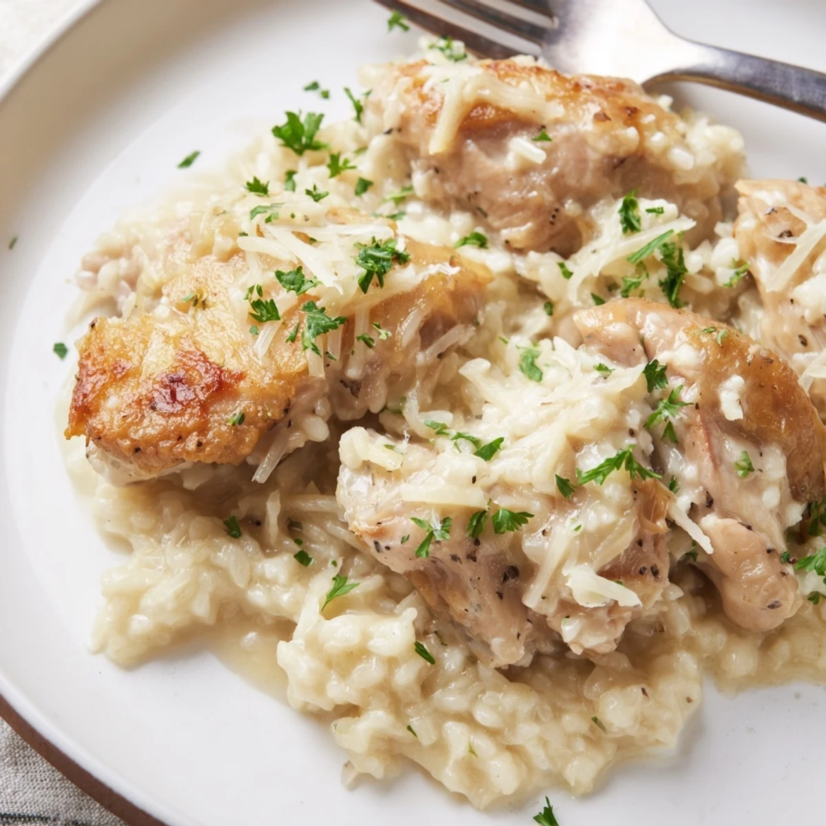 A creamy One-Pot Garlic Parmesan Chicken and Rice garnished with fresh parsley.  