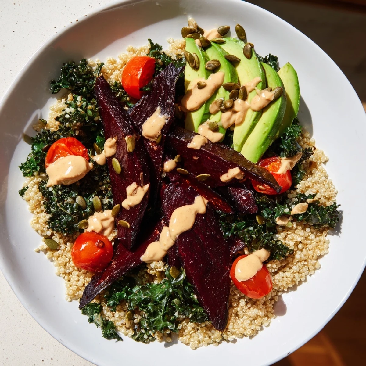 Vibrant image: A close-up of a Quinoa, Kale & Roasted Beet Bowl, ready to enjoy for lunch or dinner.