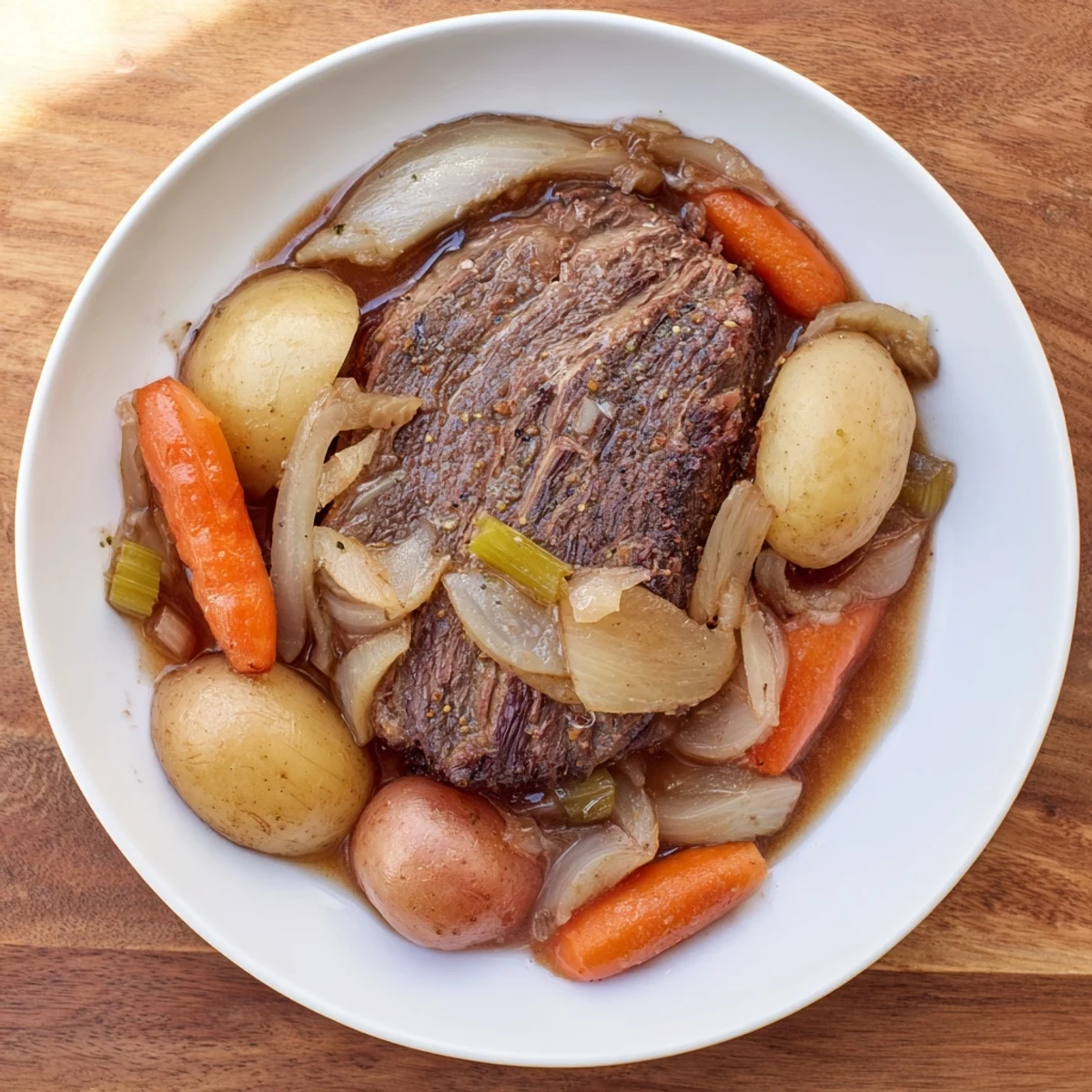 Fork-tender Pickle Brine Pot Roast, slow-cooked with aromatic vegetables, offering a taste of savory comfort food.