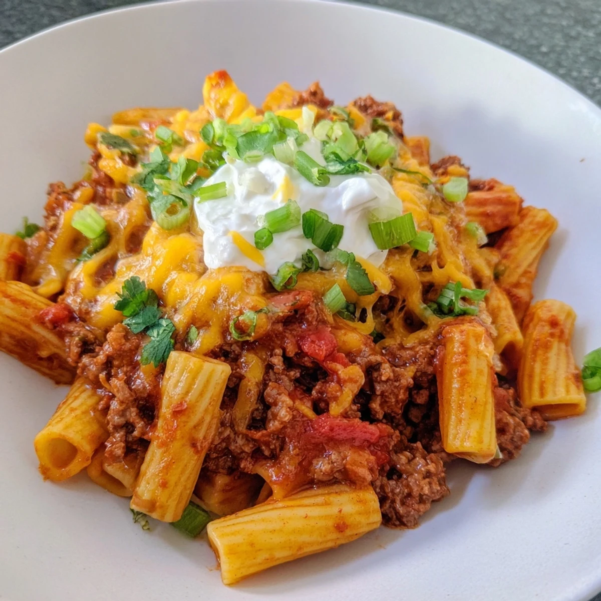 One-pot Easy Beef Enchilada Pasta, showcasing melted cheese over savory ground beef and pasta.