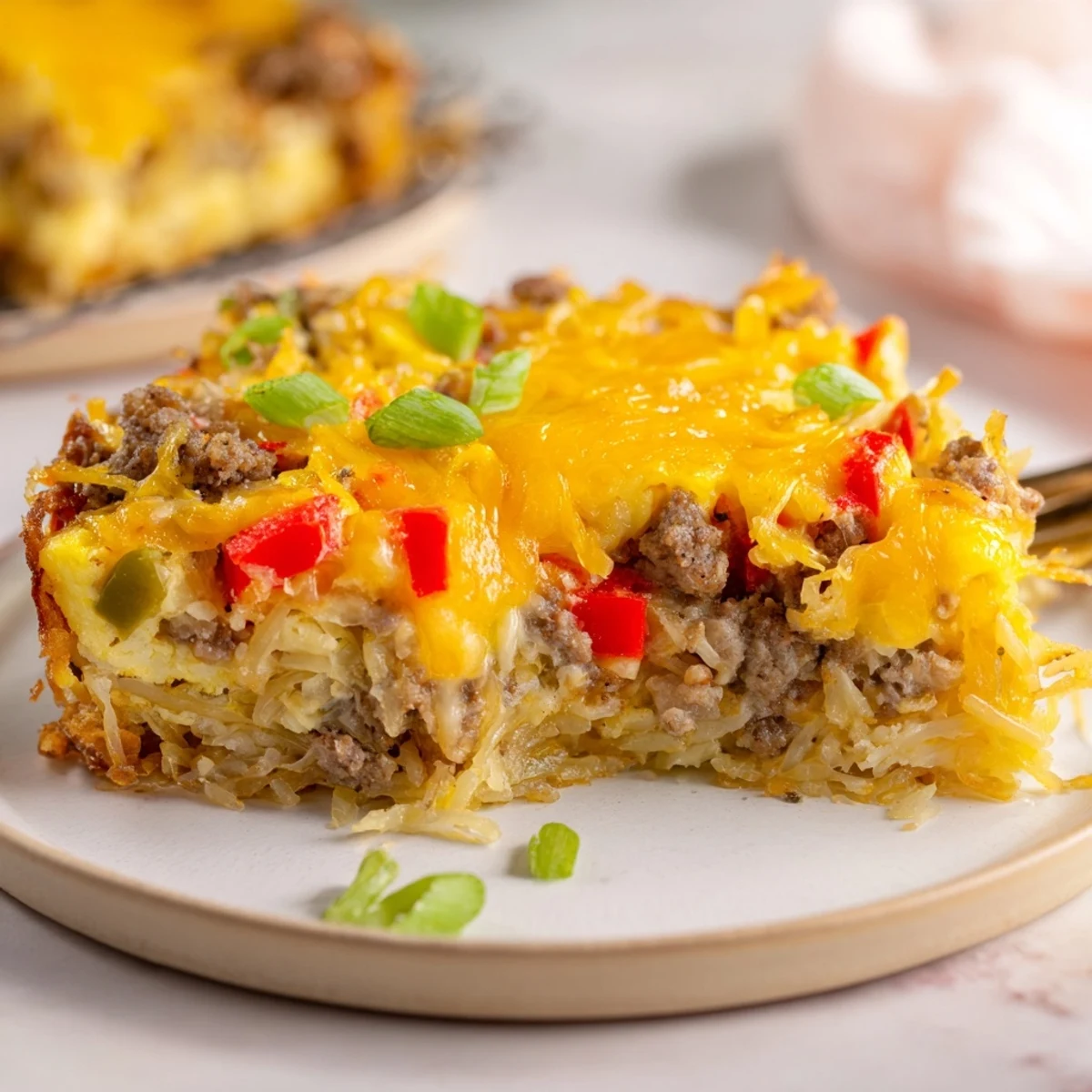 A close-up of a Quick Christmas Morning Hash Brown Bake, showing the crispy hash browns and egg mixture.