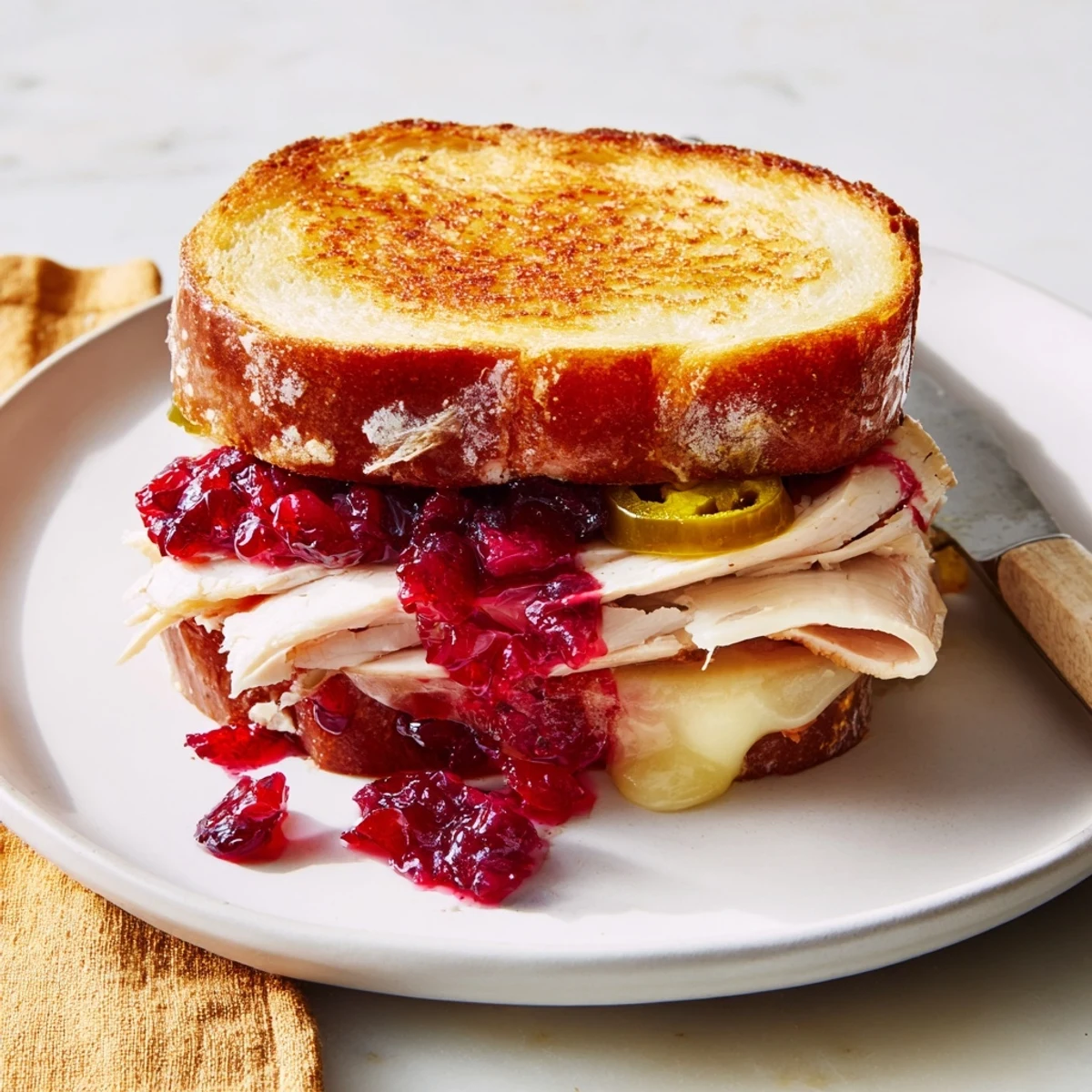 Warm, toasted Air Fryer Jalapeño Cranberry Turkey Grilled Cheese, perfect for lunch, with the tangy cranberry sauce visible.