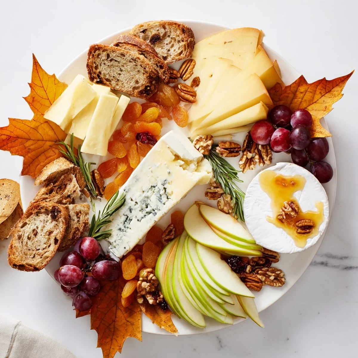 Golden cheddar, creamy brie, and blue cheese star on this Autumn Leaf Cheese Platter, perfect for a fall gathering.