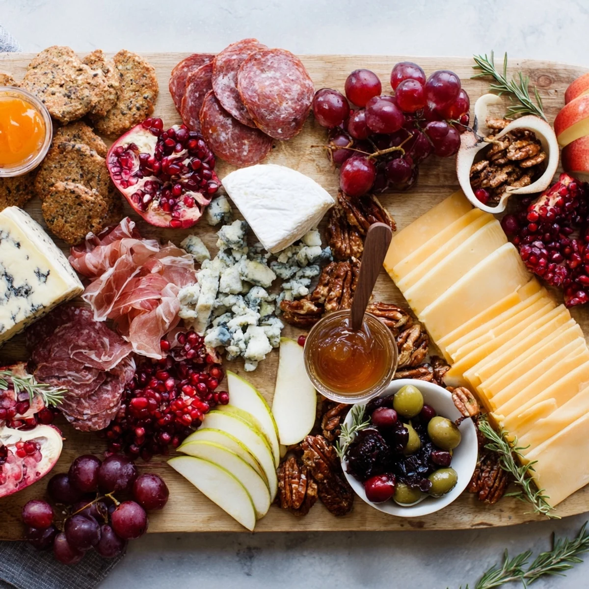 A bountiful and vibrant Jingle Bell Cheese Board display—featuring colorful grapes and delicious cheeses.