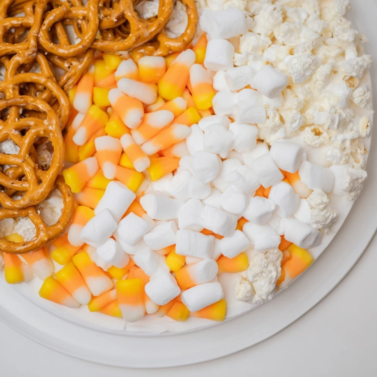 Delicious and colorful Candy Corn Spooky Board featuring cheese cubes, pretzels, and fruit for everyone.