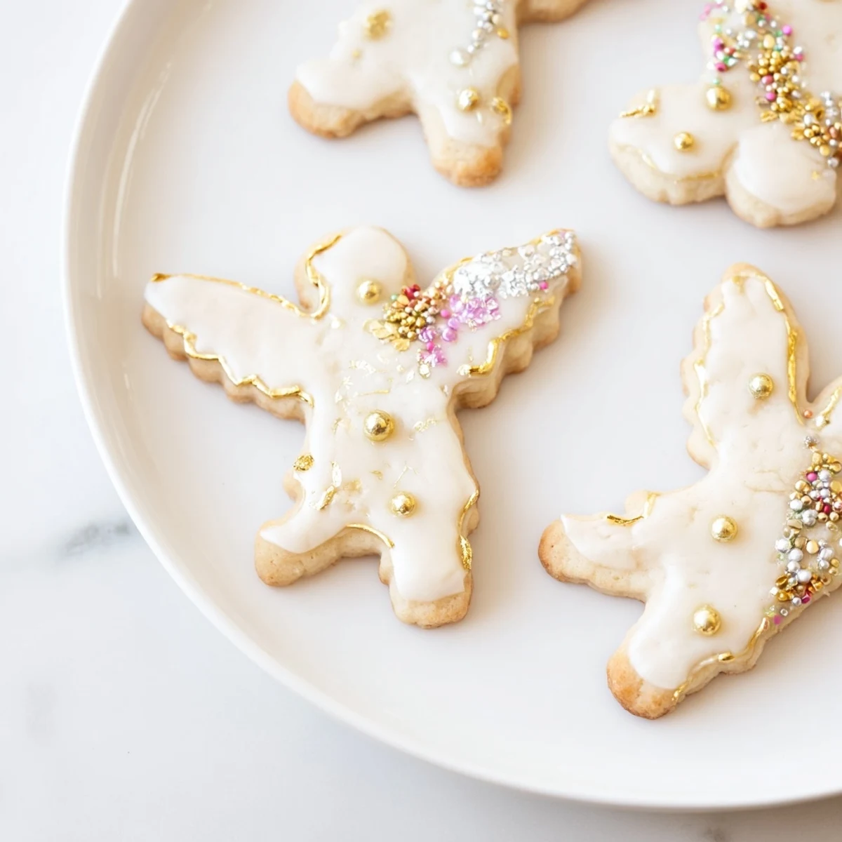 Festive Biscuits Anges de Noël with gold and silver pearl sprinkles, ideal for a holiday dessert display.