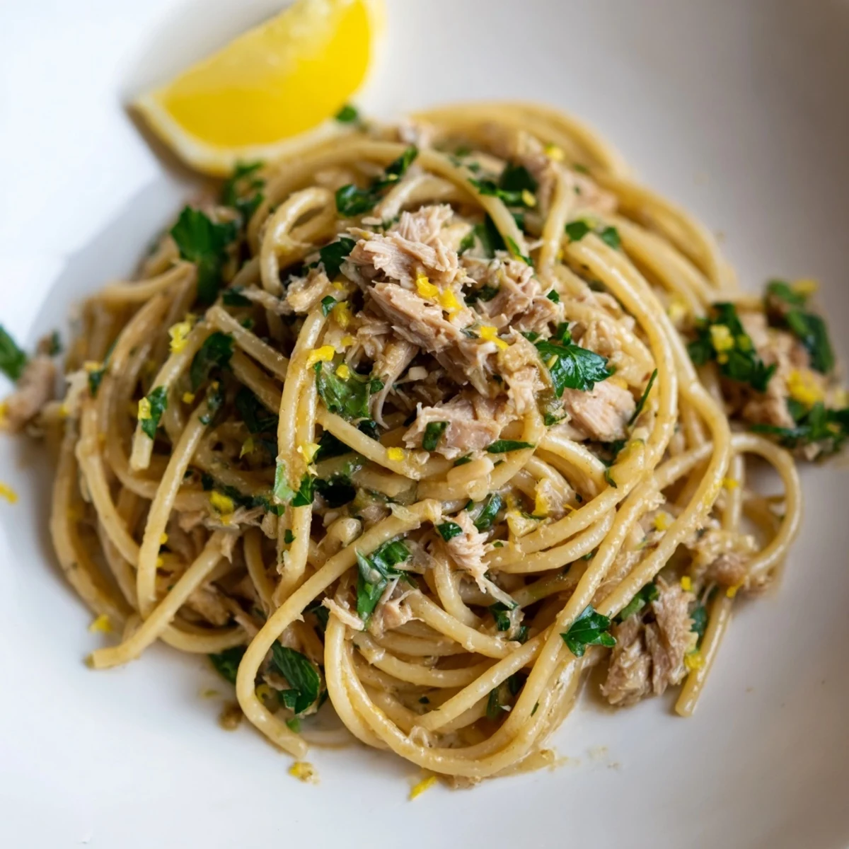 Tender spaghetti coated in a flavorful lemon and garlic sauce with flaked tuna; the perfect Lemon-Garlic Tuna Spaghetti.