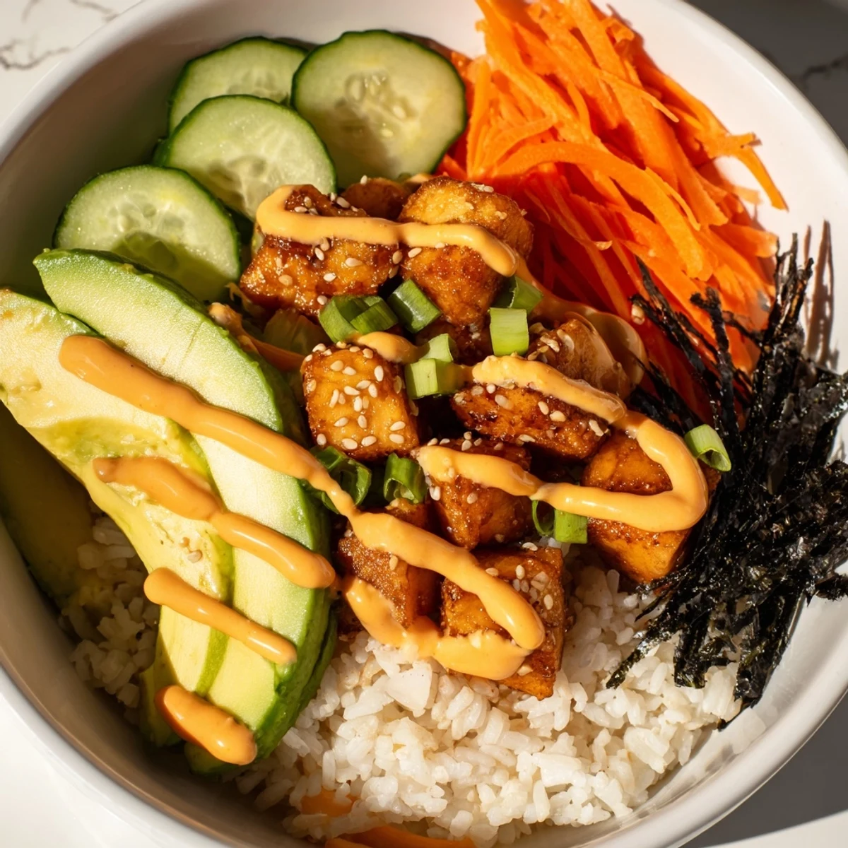 Golden-brown, crispy salmon bites bowl, a colorful delight served over fluffy rice, ready to eat.