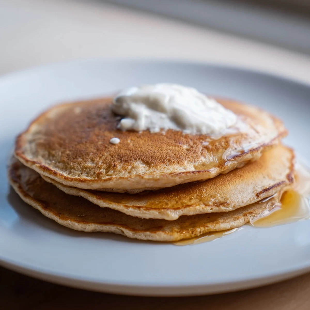 A close-up of fluffy protein banana pancakes, served with berries, a healthy and delicious start.