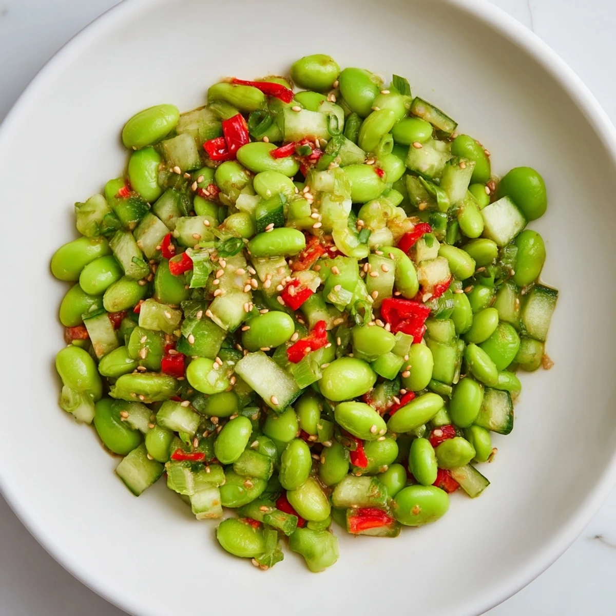 Easy Asian-inspired edamame salad recipe, featuring chopped vegetables and a flavorful dressing.