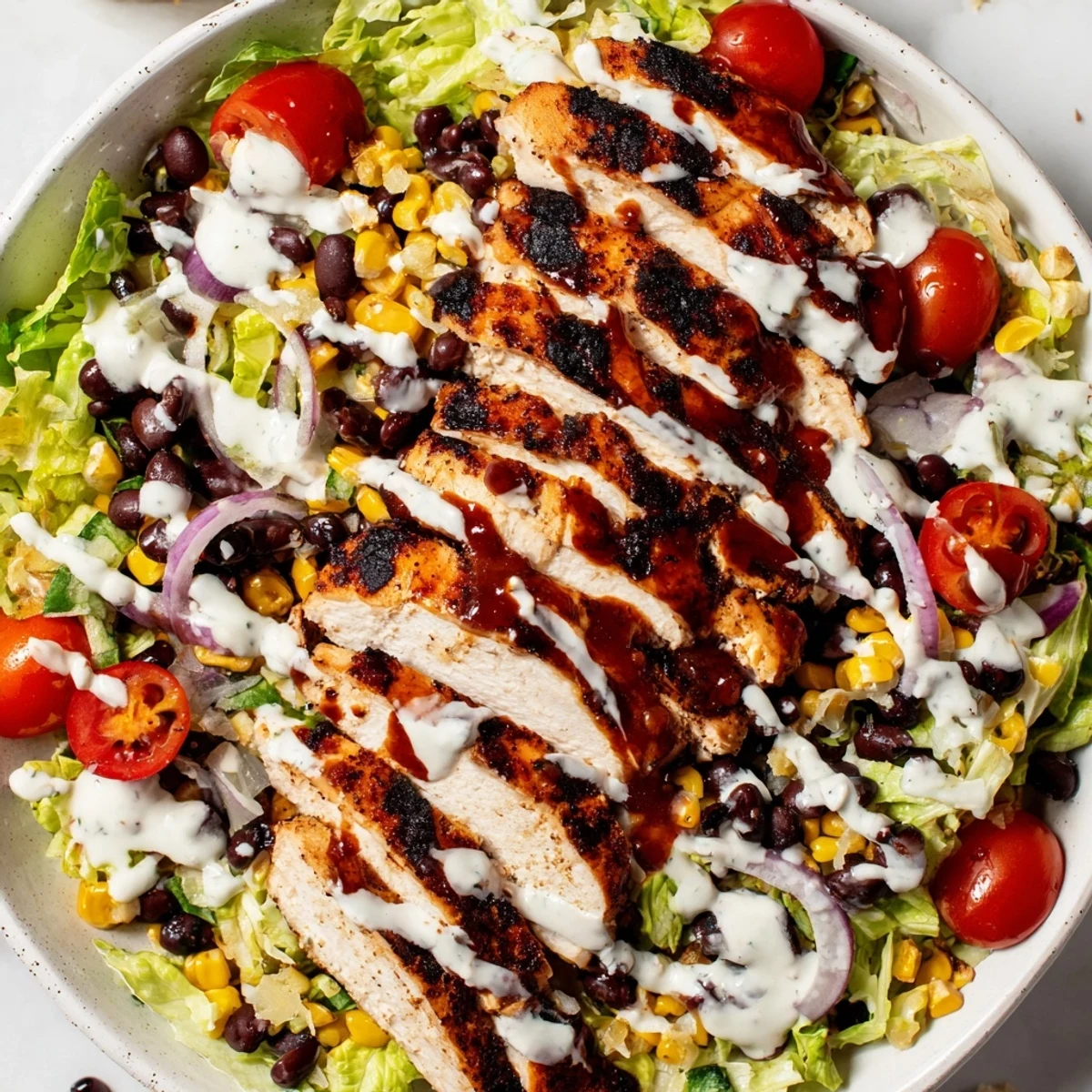 A vibrant BBQ Chicken Salad features juicy grilled chicken, sweet corn, and fresh tomatoes, ready for a satisfying weeknight dinner.  