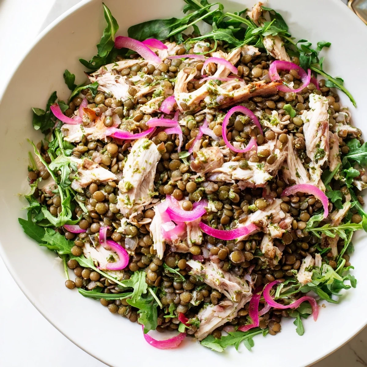 Vibrant bowl of Lentil & Chicken Spring Salad featuring protein-packed lentils, roasted chicken, cherry tomatoes, and peppery greens drizzled with a zesty Dijon vinaigrette.