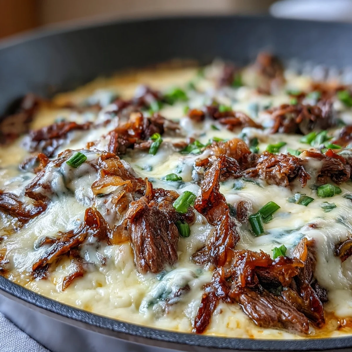 A hot, creamy party dip featuring shaved ribeye, sautéed peppers and onions.