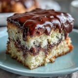 Two-tier vanilla sponge cake with buttercream and balloon toppers, perfect for graduation celebrations.