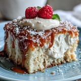 Festive Tres Leches Cupcakes featuring moist vanilla cake drenched in creamy milk soak, finished with light whipped cream and berries.