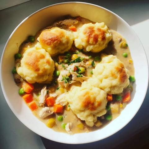 Golden-brown Chicken and Dumplings Casserole bubbling in a baking dish, ready to be served.
