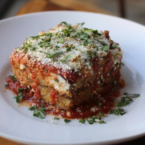 Golden, bubbly Eggplant Parmesan Lasagna with layers of tender eggplant and rich tomato sauce looks delicious.