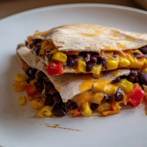 Golden, bubbly baked tortilla wrap hack with melted cheese and a vibrant bean filling.