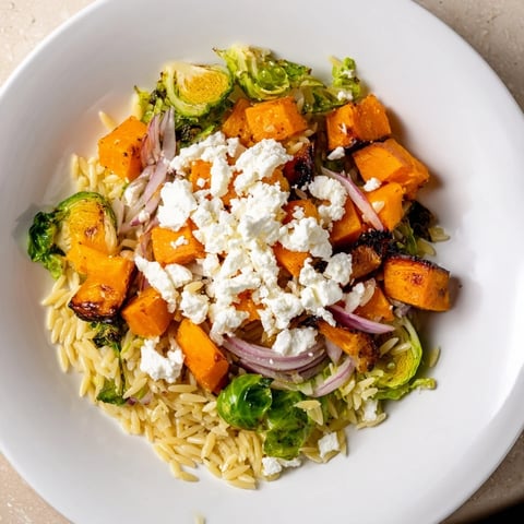 Brightly colored Best Fall Harvest Orzo Salad with roasted butternut squash and creamy goat cheese.