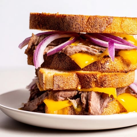 Golden-brown Smashed Burger Grilled Cheese, oozing melted cheddar, is a delicious American comfort food.