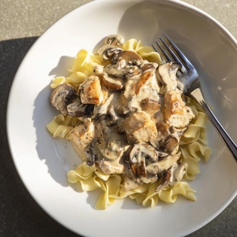 Golden, sautéed chicken and cremini mushrooms simmer in a rich, creamy paprika sauce, served over buttery egg noodles.