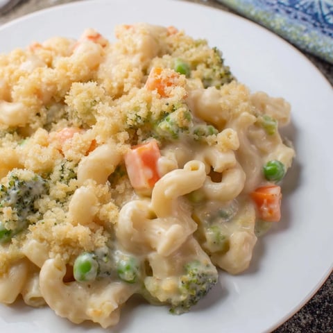 Golden, bubbling Garden Veg Mac and Cheese with peas, broccoli, and carrots baked in a creamy cheddar sauce.