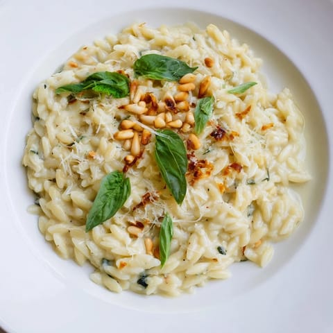 Golden, cheesy 15-Minute Creamy Pesto Risoni—a quick weeknight meal with garlic-infused pesto.