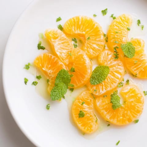 Bright clementines and mint leaves tossed in this easy winter fruit salad, ready to enjoy.