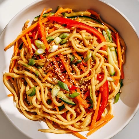 Aromatic Garlic Noodle Salad boasts a dressing coating the noodles with carrots and cilantro, a delicious meal.