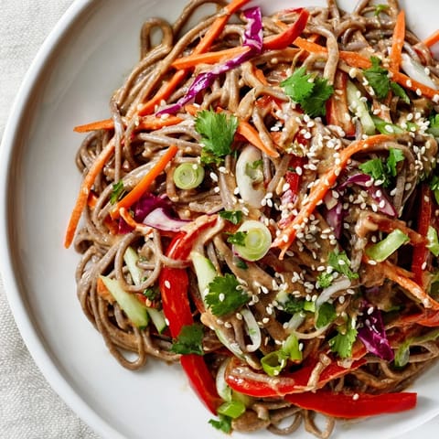 Vibrant soba noodle salad featuring buckwheat noodles, crunchy vegetables, and a savory dressing.