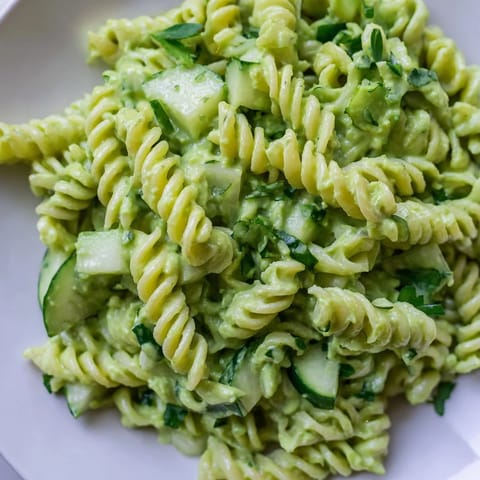 Close-up of Green Goddess Pasta Salad with vibrant spinach and herbs tossed in creamy dressing.