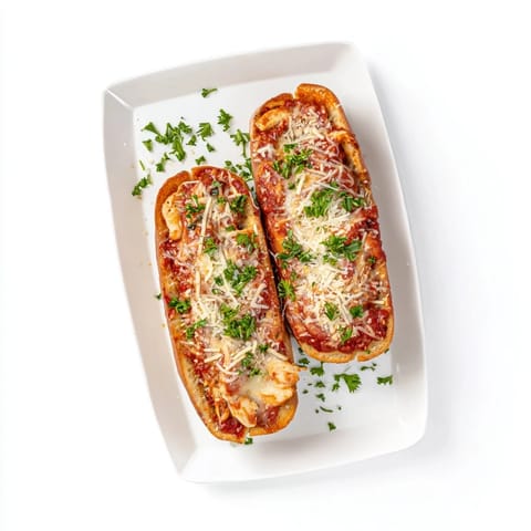 Freshly baked Chicken Parm Stuffed Garlic Bread bubbling with cheese, perfect for a hearty Italian-American appetizer.