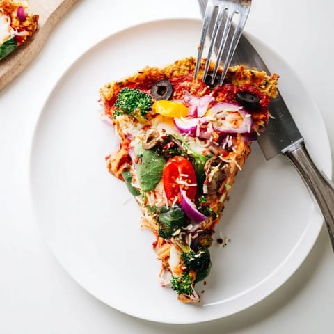 Delicious Broccoli Chicken Crust Pizza, bubbling with melted cheese, ready to slice.