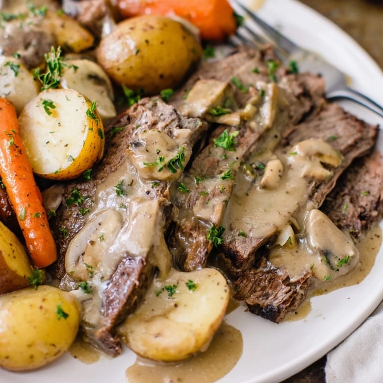 Melt-in-your-mouth Slow Cooker Creamy Pot Roast served with buttery mashed potatoes.  