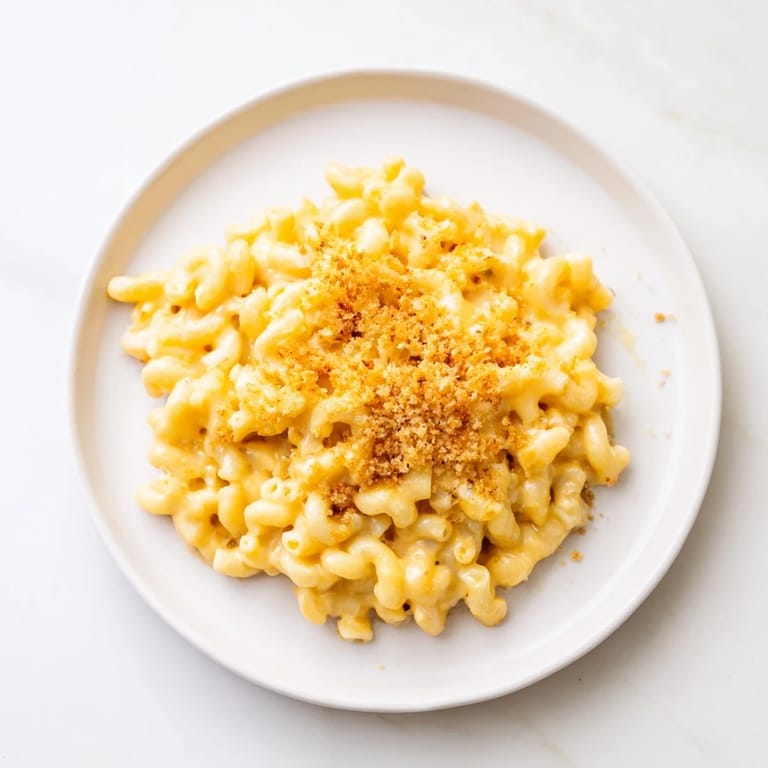 Golden-topped Easy Tinis Mac & Cheese, with a creamy, rich cheese sauce, perfect for a cozy dinner.