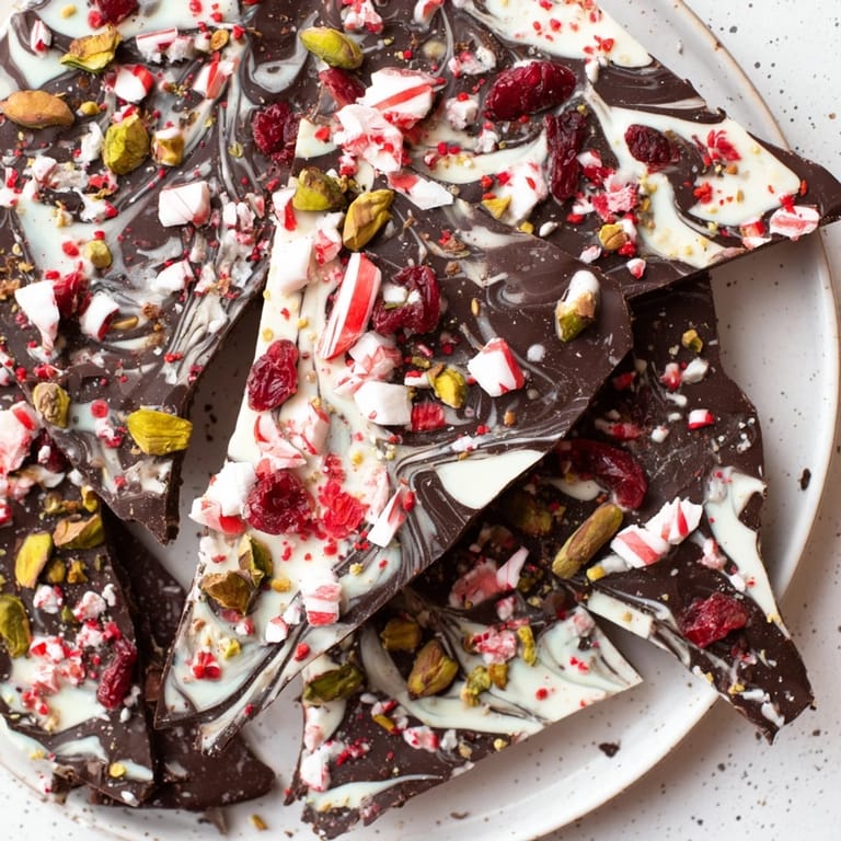 Delicious Holiday Bark, showcasing a close-up of colorful peppermint, coconut, and nut-studded chocolate pieces.