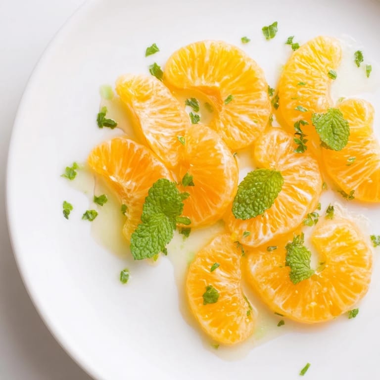 Bright clementines and mint leaves tossed in this easy winter fruit salad, ready to enjoy.
