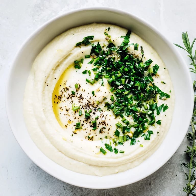Close-up of homemade veggie ranch dip, a flavorful, easy snack with vibrant green chives sprinkled on top.