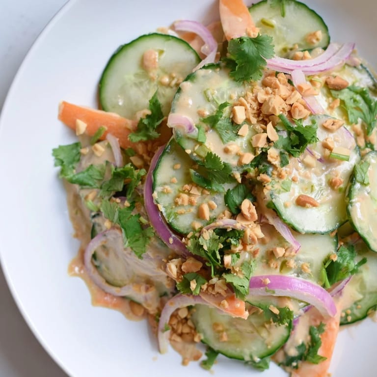 A close-up shot of the colorful Thai-Style Peanut Cucumber Salad, bursting with fresh flavors and textures.