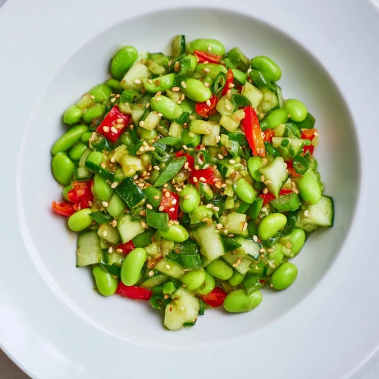 A beautiful bowl of edamame salad showcasing chilled edamame, and fresh green garnishes.