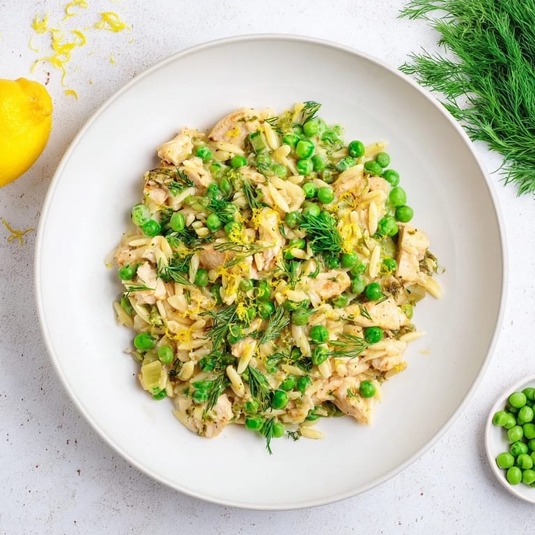 A hearty one-pan Lemon Herb Chicken Orzo Skillet garnished with fresh parsley and dill, ready to serve.