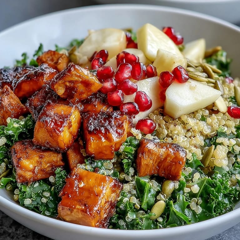 Overhead view of a Kale Harvest Grain Bowl dressed in tangy apple cider vinaigrette, ready to serve.