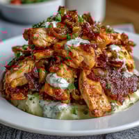 Slow Cooker Mississippi Chicken with creamy garlic mashed potatoes, tender shredded chicken in zesty ranch sauce.  